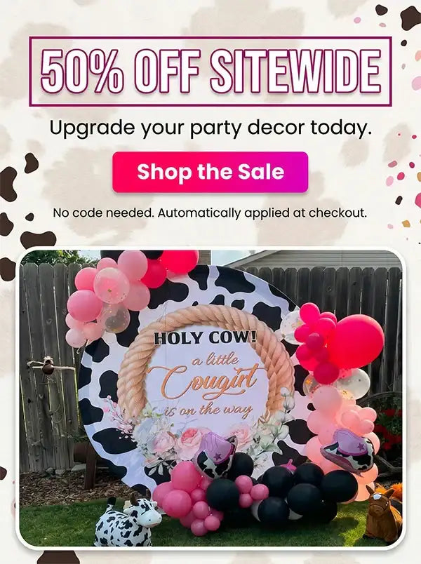 A black and white cow print backdrop with a rope frame, featuring the text ’holy cow! A little cougirt is on the way’ in gold cursive script.